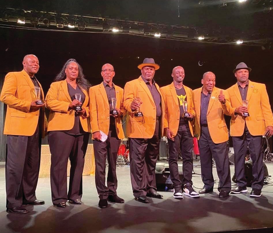 Jimmy Spencer, Evette Lyman, Jerry Seymore, Rickey Jackson, Santonio Holmes, Milton Watson and Jessie Hester, inductees to the inaugural class of the Muck City Sports Hall of Fame, receive recognition at the Dolly Hand Cultural Arts Center at the PBSC Belle Glade campus on June 5.